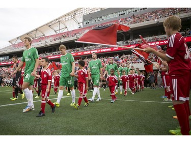 Ottawa Fury FC and New York Cosmos players enter the stadium during their NASL soccer match-up at TD Place in Ottawa, July 20, 2014.