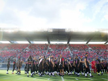 Ottawa Fury FC and the Redblacks gather together on the field at the official opening of TD Place at Lansdowne Wednesday July 9. 2014.