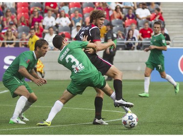 Ottawa Fury FC forward Tom Heinemann (right) fights for the ball against the New York Cosmos defenceman Hunter Gorskie (left) during their NASL soccer match-up at TD Place in Ottawa, July 20, 2014.