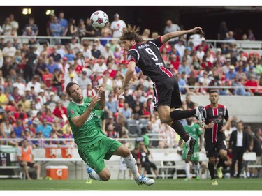 Ottawa Fury FC forward Tom Heinemann (right) heads the ball past New York Cosmos defenceman Hunter Gorskie (left) during their NASL soccer match-up at TD Place in Ottawa, July 20, 2014.