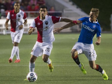 Ottawa Fury FC Mauro Eustaquio, left, fights for the ball with Rangers FC Dean Shielsr, right, as the Ottawa Fury FC hosted the Scottish League One champion Rangers FC in the first ever international friendly game at TD Place on Wednesday, July 23, 2014.