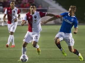 Ottawa Fury FC Mauro Eustaquio (left) fights for the ball with Rangers FC Dean Shielsr (right) at TD Place in Ottawa during an international friendly match-up between Ottawa Fury FC and Rangers FC, July 23, 2014.