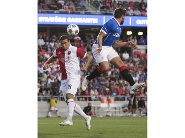 Ottawa Fury FC Vini Dantas, left, heads the ball past Rangers FC Darren McGregor as the Ottawa Fury FC hosted the Scottish League One champion Rangers FC in the first ever international friendly game at TD Place on Wednesday, July 23, 2014.