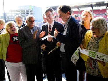 Ottawa Mayor Jim Watson and Roger Greenberg, Chairman of the Ottawa Sports and Entertainment Group, cut the ribbon at the official opening of TD Place at Lansdowne Wednesday July 9. 2014.