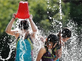 Children cool off at the Hintonburg Park in this file photo.
