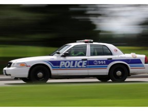 Ottawa police cruiser with lights and siren on Carling Ave. in Ottawa, Wednesday, June 18, 2014. Mike Carroccetto / Ottawa Citizen