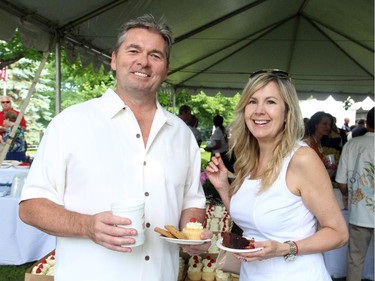Ottawa Police Insp. Paul Johnston and his wife, Johanne, satisfy their sweet tooth at the U.S. Embassy's annual Independence Day party held Friday, July 4, 2014, in Rockcliffe Park.