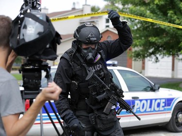 Ottawa police tactical squad execute a search warrant at a home located at 19 Topley Cres. in Hunt Club area (Ottawa), Friday, July 18, 2014. The CBRNE unit was involved. Details on what led to the raid are unknown at this time. Mike Carroccetto / Ottawa Citizen