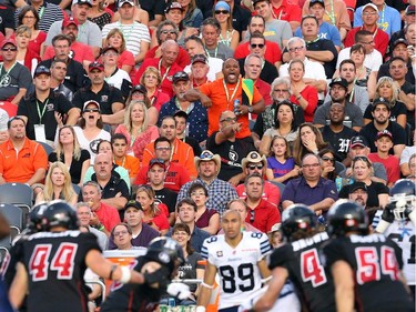 Ottawa Redblacks fans in action against the Toronto Argonauts at TD Place in Ottawa during the franchise home opener of the Redblacks on Friday, July 18, 2014.