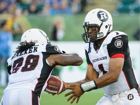 Henry Burris #1 of the Ottawa Redblacks hands the ball of to Chevon Walker #29 during a CFL game against the Edmonton Eskimos at Commonwealth Stadium on July 11, 2014 in Edmonton, Alberta, Canada.