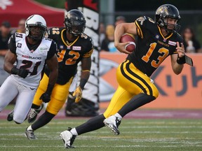 Hamilton quarterback Dan LeFevour carries the ball during game action against the Ottawa Redblacks.