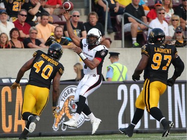 Henry Burris throws a pass during CFL game action against the Hamilton Tiger-Cats Saturday night.