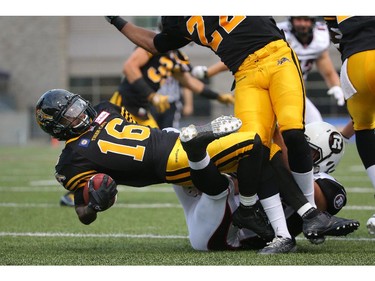 Brandon Banks #16 of the Hamilton Tiger-Cats is tackled as he returns a kick during CFL game action against the Ottawa Redblacks on July 26, 2014 at Ron Joyce Stadium in Hamilton, Ontario, Canada.
