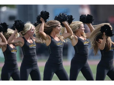 Hamilton Tiger-Cats cheerleaders rehearse before the start of CFL game action against the Ottawa Redblacks on July 26, 2014 at Ron Joyce Stadium in Hamilton, Ontario, Canada.