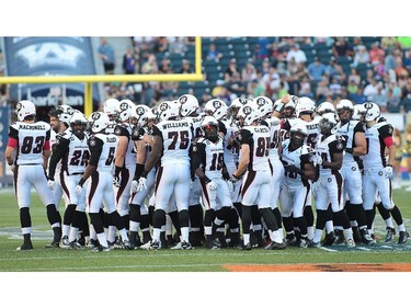 The Ottawa RedBlacks make their way to the bench after meeting at centre field prior to first half action in a CFL game against the Winnipeg Blue Bombers at Investors Group Field on July 3, 2014 in Winnipeg, Manitoba, Canada. It is the first CFL regular season game for the Ottawa RedBlacks.