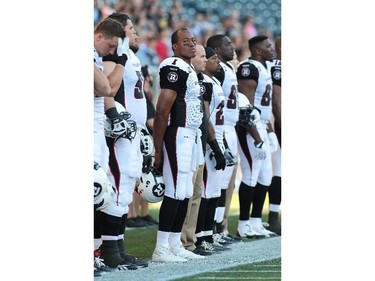 Quarterback Henry Burris #1 of the Ottawa RedBlacks looks around just before the playing of the national anthem in first half action in a CFL game against the Winnipeg Blue Bombers at Investors Group Field on July 3, 2014 in Winnipeg, Manitoba, Canada. It is the first CFL regular season game for the Ottawa RedBlacks.