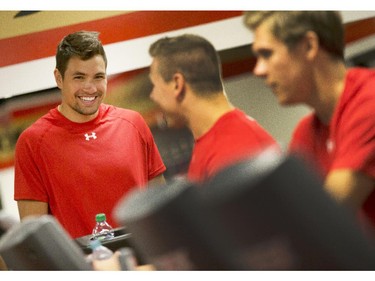 Ottawa Senators' Cody Ceci has a laugh with Darren Kramer, center, as they warm up before  taking part in the 2014 Development Camp at the Canadian Tire Centre Tuesday, July 1, 2014.