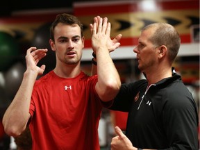 Ottawa Senators' NHL prospect Ben Harpur (L) gets some help from Chris Schwarz (R), Conditioning Coach, during their annual development camp at Canadian Tire Centre in Ottawa on July 03, 2014.