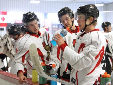 Ottawa Senators' NHL prospects Troy Rutkowski, left, Mark Stone, middle, and Ryan Dzingel at the boards during their annual development camp at the Bell Sensplex on Friday, July 4, 2014.