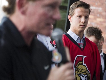 Ottawa Senators' president Cyril Leeder talks during a ceremonial grand opening of Sens House, the official sports bar of the Ottawa Senators, while new Senator, Alex Chiasson, looks on in the Byward Mark at 73 York St. Thursday, July 24, 2014.