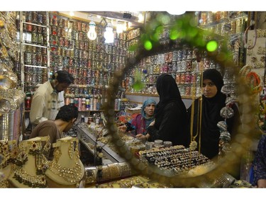 Pakistani women buy jewellery at a market ahead of the Muslim festivities of Eid al-Fitr in Lahore on July 27, 2014. Muslims around the world are preparing to celebrate the Eid al-Fitr holiday, which marks the end of the fasting month of Ramadan.