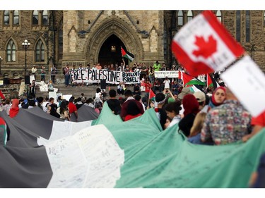 People gather on Parliament Hill on Saturday, July 26, 2014 as they call for an end to the war in Gaza.