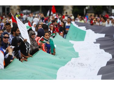 People gather on Parliament Hill on Saturday, July 26, 2014 as they call for an end to the war in Gaza.