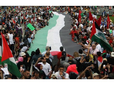 People gather on Parliament Hill on Saturday, July 26, 2014 as they call for an end to the war in Gaza.