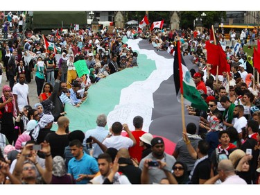 People gather on Parliament Hill on Saturday, July 26, 2014 as they call for an end to the war in Gaza.
