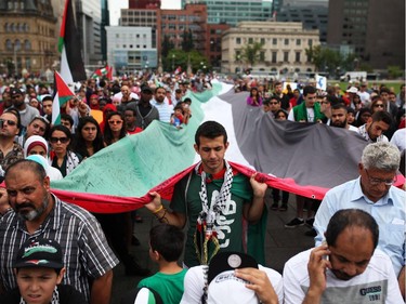 People gather on Parliament Hill on Saturday, July 26, 2014 as they call for an end to the war in Gaza.