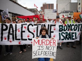 People march to Parliament Hill on Saturday, July 26, 2014 as they call for an end to the war in Gaza.