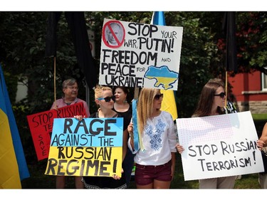 People protest outside the Russian Embassy as tension grows in Ukraine and Russia over the downing of a Malaysian Passenger Jet this past week.