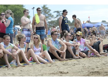 People take in the scene at the HOPE Volleyball Summerfest at Mooney's Bay Beach in Ottawa on Saturday, July 12, 2014.