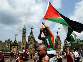 People take part in a protest and march in Ottawa on Tuesday July 22, 2014, calling for Canada to defend human rights in Palestine.
