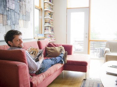 Light floods into the front of the house through floor-to-ceiling windows. It's the perfect spot for Peter Kincaid to read with a view through the trees to the river.