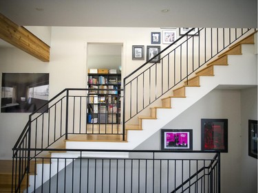 A platform in the middle of the open, streamlined staircase provides an entrance to the home office.