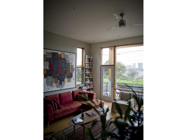 The living room, taken from the mezzanine platform of the stairs. The painting above the sofa is by local artist Dominik Sokolowski. The owners met him while building the house. Sokolowski liked the shapes (they reminded him of his work), came to the door, introduced himself and they have been close friends ever since. He has even used pieces of the house plans in his multi-media collage work.