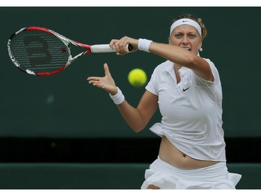 Petra Kvitova of Czech Republic hits a return to Eugenie Bouchard of Canada during the women's singles final at the All England Lawn Tennis Championships in Wimbledon, London, Saturday, July 5, 2014.