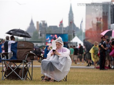 Ponchos, such as the one Carrie Reid is wearing, and umbrellas were the order of the day at Bluesfest on Tuesday evening.