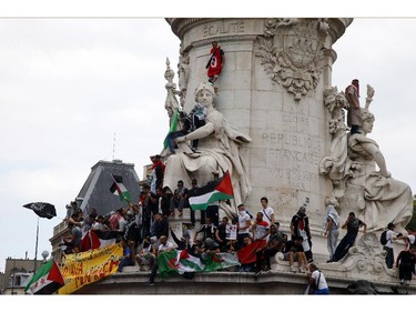 Pro-Palestinian protesters gather at Place de La Republique during a banned demonstration in support of Gaza, in Paris, France, Saturday, July 26, 2014. A brief cease-fire Saturday in the Gaza war between Israel and Hamas militants allowed thousands to return home to see the destruction. Palestinians walked through the concrete rubble that once used to be homes, collecting what keepsakes they could recover.