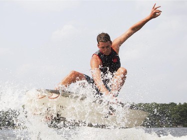 Pro wake surfer, Chase Hazen, catches some air as he competes in the Canadian Wake Surf Nationals in Calabogie Lake Friday July 25, 2014. The premier wake surfing event runs until Sunday.