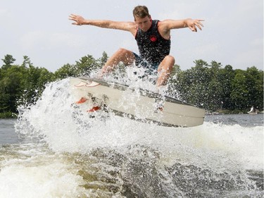 Pro wake surfer, Chase Hazen, catches some air as he competes in the Canadian Wake Surf Nationals in Calabogie Lake Friday July 25, 2014. The premier wake surfing event runs until Sunday.
