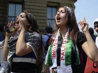 Protesters shout during a rally in front of the Langevin Block in support of Palestinians in Gaza in Ottawa on Tuesday, July 22, 2014.