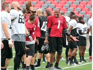 QB Henry Burris, centre, makes his teammates laugh, seemingly with some impressions during drills as the Ottawa Redblacks practice through a downpour Tuesday morning at TD Place Stadium at Lansdowne Park.