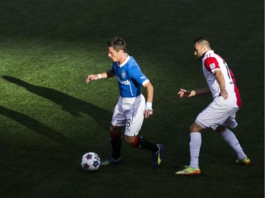 Rangers FC Ian Black, left, moves the ball past Ottawa Fury FC Sinisa Ubiparipovic as the Ottawa Fury FC hosted the Scottish League One champion Rangers FC in the first ever international friendly game at TD Place on Wednesday, July 23, 2014.