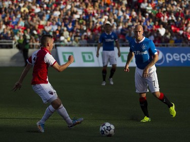 Rangers FC Nicky Law, right, makes his way past past Ottawa Fury FC Carl Haworth, left, as the Ottawa Fury FC hosted the Scottish League One champion Rangers FC in the first ever international friendly game at TD Place on Wednesday, July 23, 2014.