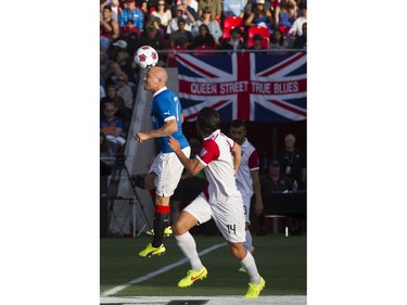 Rangers FC Nicky Law, left, heads the ball past Ottawa Fury FC Tony Donatelli, right, as the Ottawa Fury FC hosted the Scottish League One champion Rangers FC in the first ever international friendly game at TD Place on Wednesday, July 23, 2014.