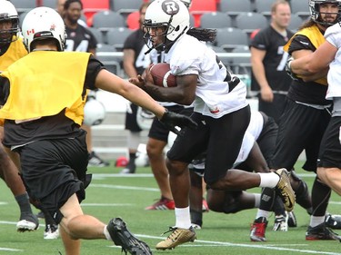 RB Chevon Walker carries the ball up the field past all manner of obstacles as the Ottawa Redblacks have their first practice at home since losing their opening season game against Winnipeg.