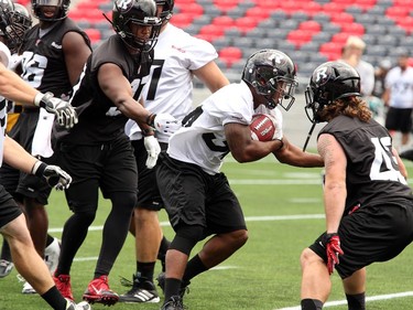 RB Michael Hayes carries the ball through heavy traffic as the Ottawa Redblacks practice at TD Place Stadium at Lansdowne Park on Monday, July 14, 2014.