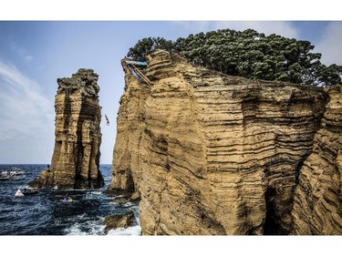 VILA FRANCA DO CAMPO, PORTUGAL - JULY 26:  (EDITORIAL USE ONLY) In this handout image provided by Red Bull, David Colturi of the USA dives from the 27 metre platform on Islet Vila Franca do Campo during the fifth stop of the Red Bull Cliff Diving World Series, Azores, Portugal.